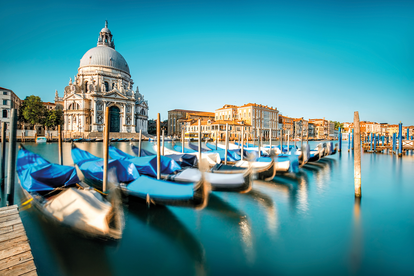 Venice cityscape view on Santa Maria della Salute basilica with gondolas on the Grand canal in Venice. Long exposure image technic with motion brured boats