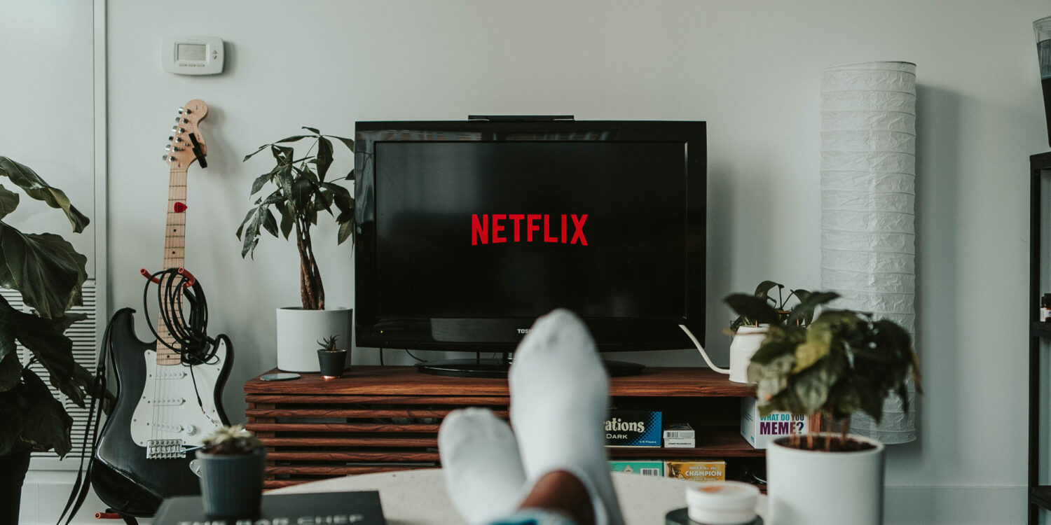 Person watching tv with Netflix logo on screen