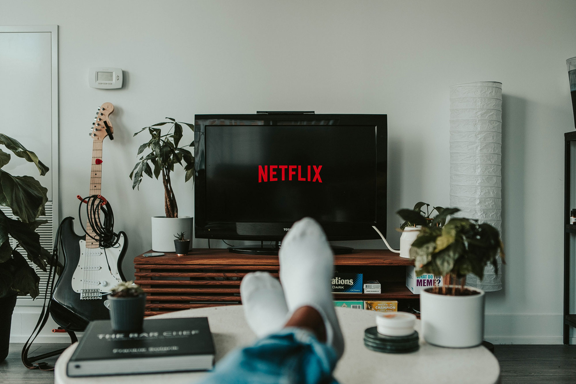 Person watching tv with Netflix logo on screen