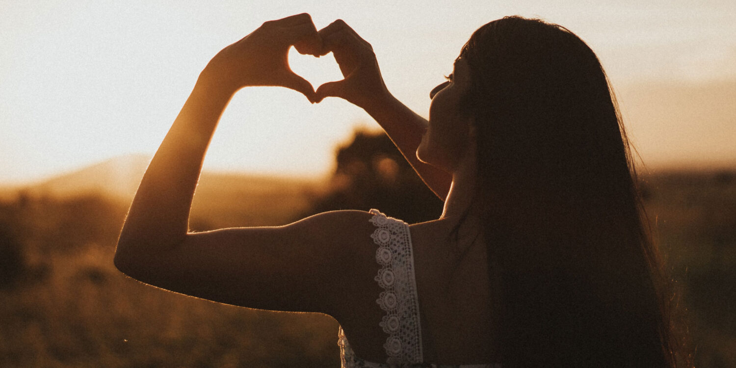 Woman showing hands shaped as a love heart