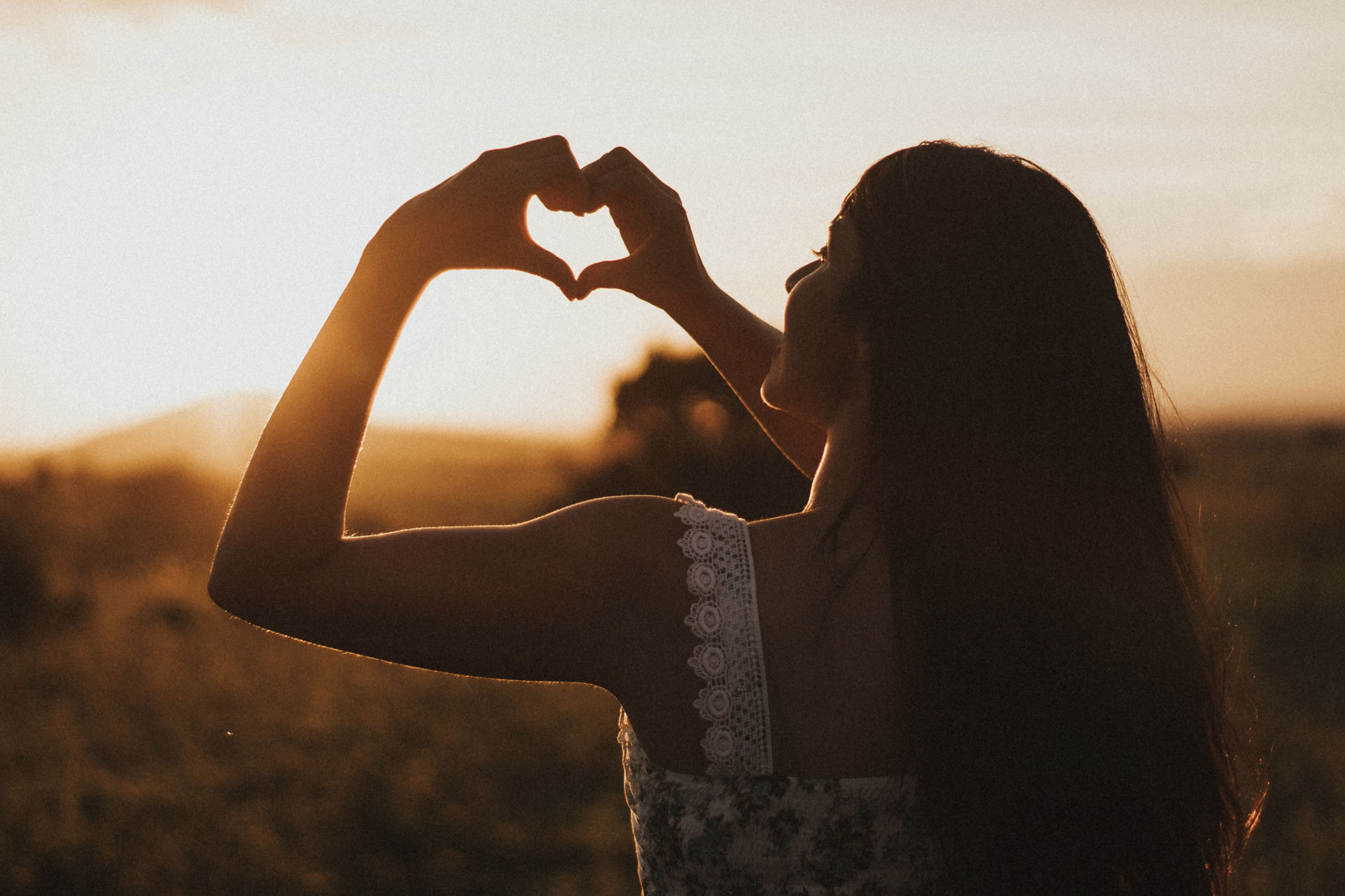 Woman showing hands shaped as a love heart