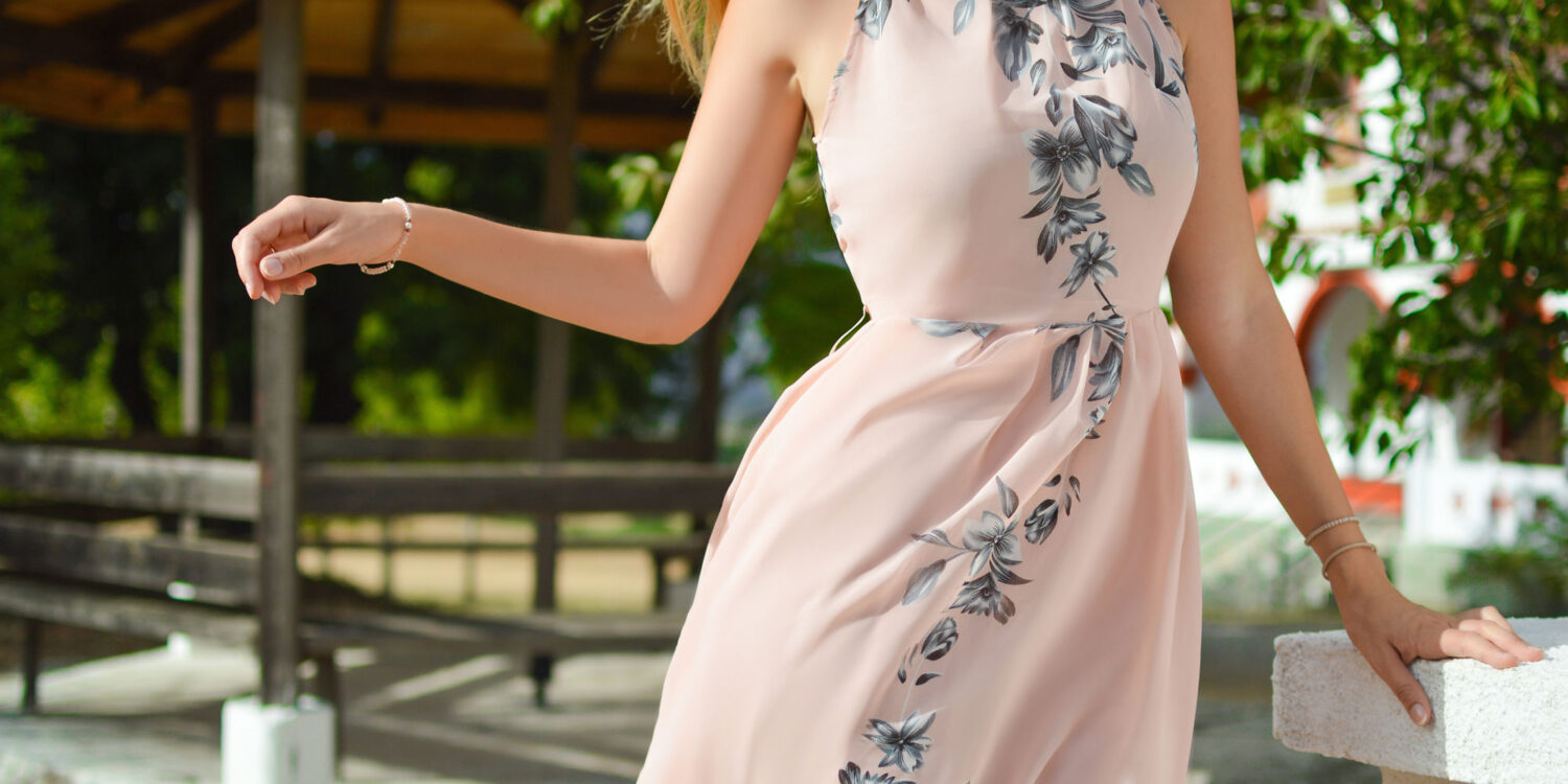 Woman wearing a beige dress with flowers